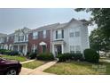 Charming townhome with well-maintained landscaping and inviting walkway, perfect for potential buyers at 12564 Jessica Pl, Charlotte, NC 28269