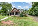 Charming home with a covered front porch and large front yard with a detached garage at 14115 Old Statesville Rd, Huntersville, NC 28078