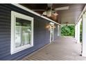 Spacious front porch with beautiful wood floors, ceiling fans, and large windows at 14115 Old Statesville Rd, Huntersville, NC 28078