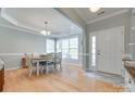 Bright dining room with hardwood floors, elegant lighting, and a large window for natural light at 14727 Brannock Hills Dr, Charlotte, NC 28278