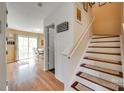 Hallway with hardwood flooring leads to an eat-in kitchen with an outdoor dining area at 1583 Cold Creek Pl, Huntersville, NC 28078