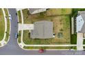 An aerial view of a home and yard, showing a playground in the fenced backyard at 16404 Wavenly House Dr, Charlotte, NC 28273