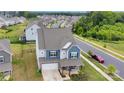 An aerial view of a beautiful home and surrounding neighborhood with mature trees and well-manicured lawns at 16404 Wavenly House Dr, Charlotte, NC 28273