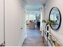 Bright entryway featuring wood floors, a round mirror, and view into the spacious and well-lit living room at 3090 Ora Smith Rd, Lincolnton, NC 28092