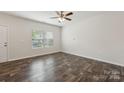Bright, open living room with hardwood floors, a ceiling fan, and plenty of natural light at 3107 Riker St, Clover, SC 29710