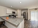 Modern kitchen with granite countertops, stainless steel appliances, and hardwood floors at 323 J C Dellinger Rd, Cherryville, NC 28021