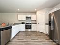 Well-equipped kitchen featuring stainless steel appliances, granite countertops, and ample cabinet space at 323 J C Dellinger Rd, Cherryville, NC 28021