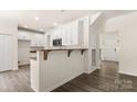 Bright eat-in kitchen featuring white cabinetry and hardwood floors at 3429 Lazy Day Ln, Charlotte, NC 28269