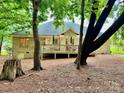 Backyard view of a brick home with a spacious wooden deck at 35 Wittenburg Springs Dr, Taylorsville, NC 28681