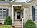 Inviting front entrance with a decorative wreath and a comfortable seating area at 35 Wittenburg Springs Dr, Taylorsville, NC 28681