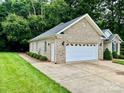 Spacious two-car garage with a side door, offering ample parking and storage at 35 Wittenburg Springs Dr, Taylorsville, NC 28681