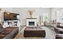Comfortable living room with a decorative fireplace, plush seating and ottoman at 3951 Tersk Dr, Midland, NC 28107