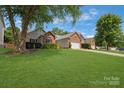 Beautiful home with a large front lawn, mature trees and a two-car garage at 4797 Chesney Nw St, Concord, NC 28027