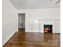 Bright living room featuring a fireplace and gleaming hardwood floors at 505 Franklin Ave, Shelby, NC 28150