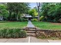 Well-maintained front yard and stone walkway lead to this charming home with a covered front porch at 506 Clement Ave, Charlotte, NC 28204