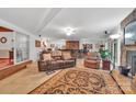 Spacious living room featuring a bar, comfortable seating, tile floors, and stylish decor, perfect for entertaining guests at 514 Wood St, Troy, NC 27371