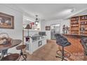 Functional wet bar with ample storage, modern appliances, and a bar-height table, ideal for casual dining and entertaining at 514 Wood St, Troy, NC 27371