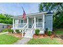 Charming home with covered porch, landscaped front yard, and American flag at 515 Myrtle Ave, Chester, SC 29706