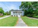 Charming home with covered porch, landscaped front yard, and walkway to the front door at 515 Myrtle Ave, Chester, SC 29706