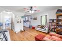 Open living room with hardwood floors, fan, and view into the kitchen at 515 Myrtle Ave, Chester, SC 29706