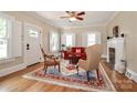 Cozy living room with hardwood floors, fireplace, and large windows with white shutters at 536 Carroll St, Statesville, NC 28625
