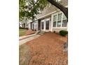 Two story tan townhouse with stone accents and landscaped front yard at 571 Goldstaff Ln, Charlotte, NC 28273