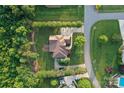 Aerial view showing the home's layout, landscaping, driveway, and surrounding lush greenery at 6302 Dwayne Starnes Dr, Hickory, NC 28602