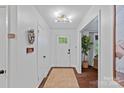 Inviting foyer features hardwood floors, fresh paint, and stylish lighting at 6946 Woodstock Dr, Charlotte, NC 28210