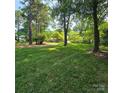 Expansive lawn and mature trees offer privacy and shade to this home at 695 Knollcrest Ne Dr, Concord, NC 28025