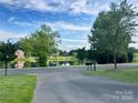 This view offers a calming pond reflecting the sky, a picturesque landscape, and a glimpse of community homes at 705 Congressional Ln, Fort Mill, SC 29708