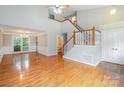 Bright and airy living room boasting soaring ceilings, hardwood floors and a staircase to the second floor at 7114 Kinsmore Ln, Charlotte, NC 28269