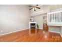 Spacious living room with hardwood floors, a fireplace with white mantle, and plenty of natural light at 7121 Bidford Ct, Indian Land, SC 29707