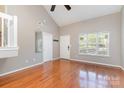 This room is light and airy with hardwood floors, tall ceilings, a large window, and a neutral paint color at 7121 Bidford Ct, Indian Land, SC 29707