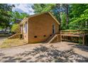 The back of this brick home features a concrete patio and stairs leading to an upper deck at 7320 Ritter Dr, Charlotte, NC 28270