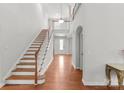Spacious entrance featuring hardwood floors, an open staircase, and recessed lighting at 7798 Sand Trap Ln, Stanley, NC 28164