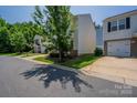 Street view featuring a two-story home with a landscaped yard and trees, surrounded by neighboring houses at 8226 Gabon Ct, Charlotte, NC 28215