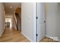 Bright entryway with hardwood floors, a staircase, and a view into the open-concept living space at 1028 Grays Mill Rd, Charlotte, NC 28215