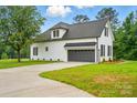 This home features a spacious two-car garage and driveway, set against the backdrop of a well-manicured lawn at 116 Eve Ash Ln, Mooresville, NC 28115