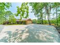 Attached brick garage with a basketball hoop and a large driveway for ample parking at 12705 Caldwell Rd, Charlotte, NC 28213