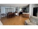 Open-concept dining area with wooden table, chandelier, and adjacent kitchen features at 13211 Asbury Chapel Rd, Huntersville, NC 28078