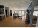 Inviting living room with a sectional sofa, and seamless flow to dining area at 13211 Asbury Chapel Rd, Huntersville, NC 28078