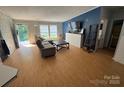 Cozy living room with a comfortable couch, entertainment center and natural light at 13211 Asbury Chapel Rd, Huntersville, NC 28078
