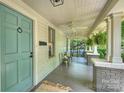Inviting covered porch with ceiling fans, brick columns, and ample space for outdoor seating at 1417 The Plz, Charlotte, NC 28205