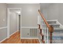Welcoming entryway with hardwood floors and a staircase with wood banister at 1517 E Barden Rd, Charlotte, NC 28226