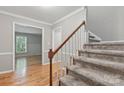 Inviting entryway with hardwood floors and carpeted stairs at 1517 E Barden Rd, Charlotte, NC 28226