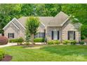 Beautiful brick home with a well-maintained lawn and landscaping, creating a welcoming curb appeal at 16527 Woolwine Rd, Charlotte, NC 28278