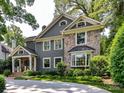 Beautiful two-story home featuring stone accents, gray siding, and a circular driveway at 2526 Sherwood Ave, Charlotte, NC 28207