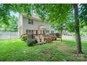 Private backyard features a wooden deck with chairs, ideal for outdoor relaxation and entertaining at 2908 Barnard Castle Ln, Matthews, NC 28104