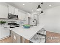 Modern kitchen features stainless steel appliances, white cabinets, a center island, and recessed lighting at 32612-B Millingport Rd # 7157, New London, NC 28127