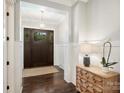 Stately foyer showcasing hardwood floors, decorative light fixture, and traditional wainscoting at 431 Wonderwood Dr, Charlotte, NC 28211